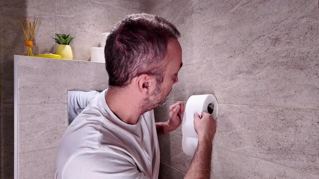 Man with urge to go to the toilet at home.