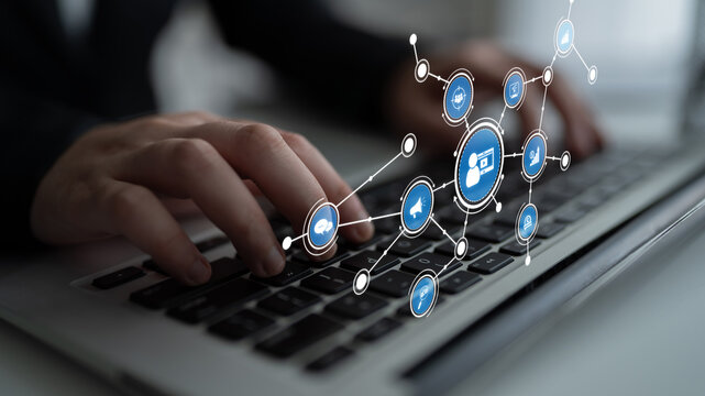 A close-up of hands typing on a laptop keyboard, surrounded by digital icons and network connections symbolizing technology, communication, and productivity in a modern workspace. Tessel