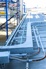 Good manage network electric cable with metal flex pipe. Isolated on white background. Installation of electrical wiring on wall. Electrical cable system installation.