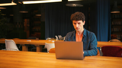 Professional man participating in a business video conference call waving hand