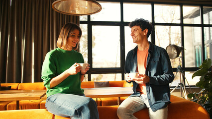 Young couple enjoying coffee and conversation in stylish cafe