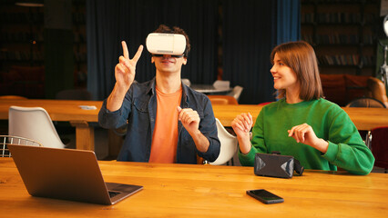 Man exploring virtual reality with woman assistant, online technology concept