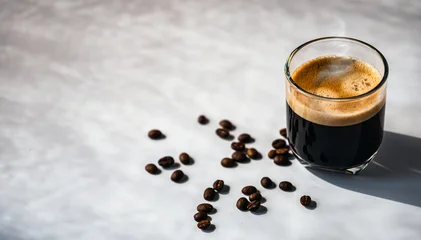 Selbstklebende Fototapeten Cafe Hot espresso coffee steam rises from hot coffee in coffee glass and bean isolated on white background in Morning sunlight  © NARONG