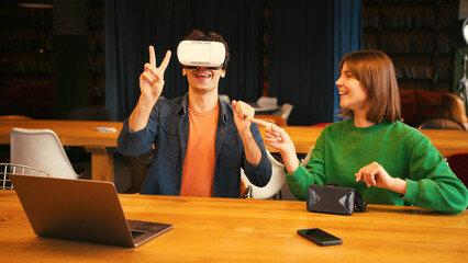Man exploring virtual reality with woman assistant, online technology concept