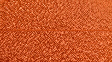 Obraz premium Detailed ro shot showcasing the intricate bumpy texture and characteristic seam of a standard orange basketball emphasizing its tactile surface for athletic play