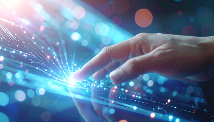 Digital touch: A close-up shot of a human hand interacting with a vibrant stream of digital data, symbolizing innovation and connection.