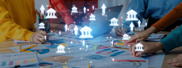 A dynamic business meeting showcasing professionals analyzing charts and graphs, with digital icons symbolizing financial trends and market growth. Trope