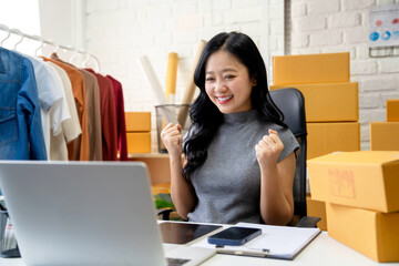 SME Startup, Small Business Entrepreneur. Successful small business owner celebrating sales, e-commerce, and online shopping success.