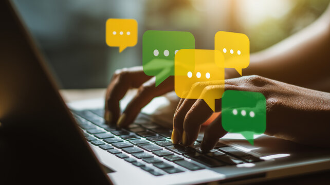 Digital communication and customer interaction represented by hands typing on a laptop surrounded by chat dialogue icons symbolizing connectivity and online engagement.
