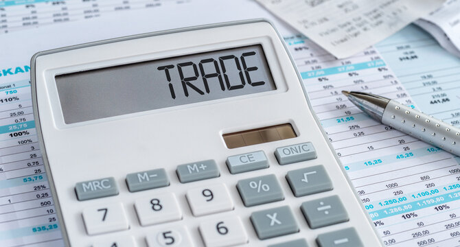 A calculator with the word Trade on the display