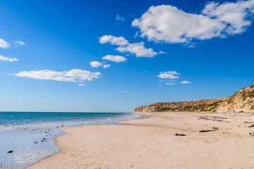 Port Willunga Beach view on a bright day with blue sky and fluffy clouds, Fleurieu Peninsula, South Australia