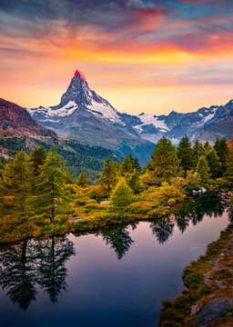 Breathtaking summer sunrise on Grindjisee lake in Swiss Alps. Astonishing morning view of  Matterhorn peak, Zermatt location, Switzerland, Europe. Beauty of nature concept background.