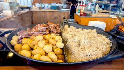Hearty Feast Potatoes, Sauerkraut, and Roasted Meat Ready to Serve at Market Stall