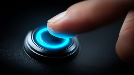 A human finger pressing a glowing circular button representing activation, decision making, interaction, and technological control.
