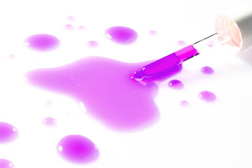 Dropper with violet-colored serum in a test tube. Cosmetic research or chemical testing in a sterile laboratory environment.