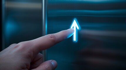 A hand presses the illuminated upward arrow button on a modern elevator panel, indicating a desire to go up