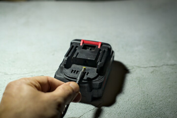 Man hold connector for li-ion battery charge