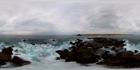 Top view of Waves crashing on a rocky island. Ahangama beach. 360 panorama VR.