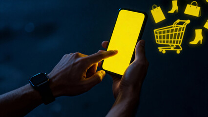 Person using smartphone for online shopping with glowing cart and items in dark background