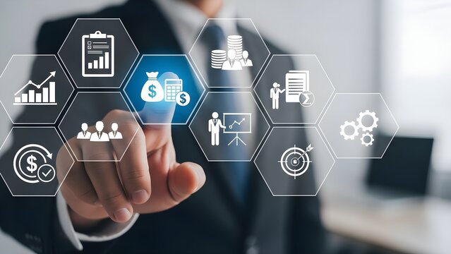 Businessman in suit touching a digital screen displaying financial icons and business concepts representing strategy, management, and teamwork.