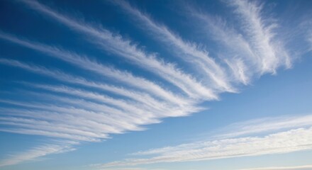 Wispy, horizontal clouds against a vibrant blue sky