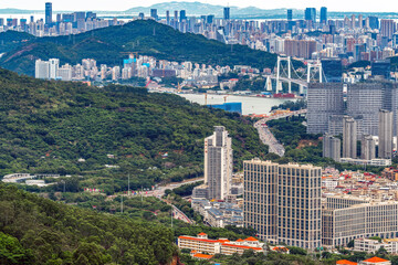 Panoramic view of urban landscape with mountains and buildings