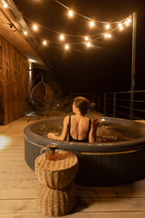 Relaxing evening in a hot tub under warm string lights