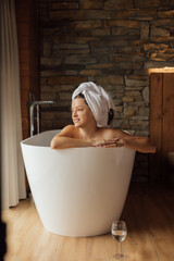 Relaxing moment in a cozy bath surrounded by natural stone walls