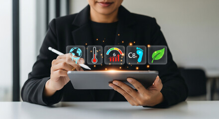 Professional analyzing environmental sustainability data on a tablet, demonstrating climate action, carbon footprint monitoring, and eco-friendly business strategies.