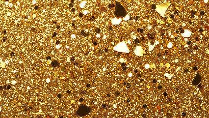 Close-up of sparkling gold glitter and reflective flakes creating a vibrant festive background.