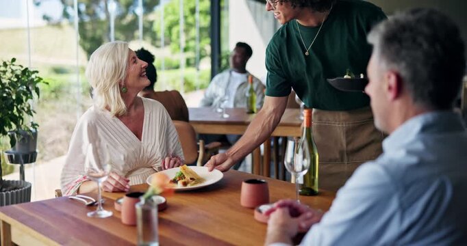 Mature, happy couple and dinner date with waiter for fine dining, order or cuisine in restaurant. Man, woman or serving plate with food, wine or alcohol for anniversary, hospitality or romantic meal