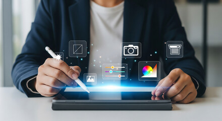 Digital content creator uses stylus on tablet, interacting with holographic icons for advanced photo editing, graphic design, and multimedia management.