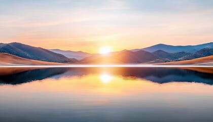 Fototapeta premium A tranquil landscape featuring a lake reflecting the sunrise, with mountains in the background, bathed in golden light.