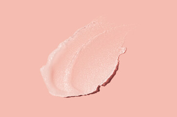 Cosmetic white translucent lip balm or face cleansing balm butter swatch on peach blusher background