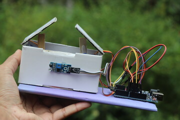 Automatic dustbin project prototype that uses infrared sensor and servos for working controlled by a programmable microntroller