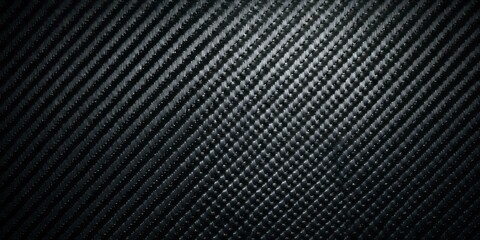 Dark textured material displays an intricate diagonal weave pattern under focused illumination