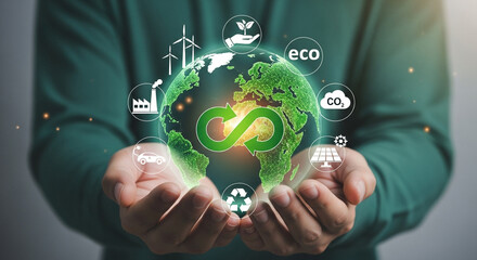 Person holding a glowing green earth with renewable energy icons symbolizing sustainability environmental conservation and ecofriendly practices for a better future and a healthy planet