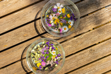 Alpine flowers and herbs macerating in water for the ritual of the Night of St. John (June 23-24), symbol of fortune and prosperity.
