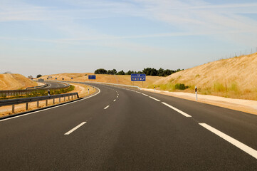 Empty paved road with exit signs in Europe.