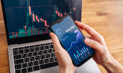 Cryptocurrency and financial charts showing digital coins, trading graphs, and investment data on a screen