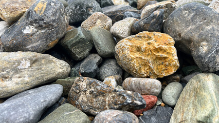 Diverse natural river rocks with textures in various sizes and colors