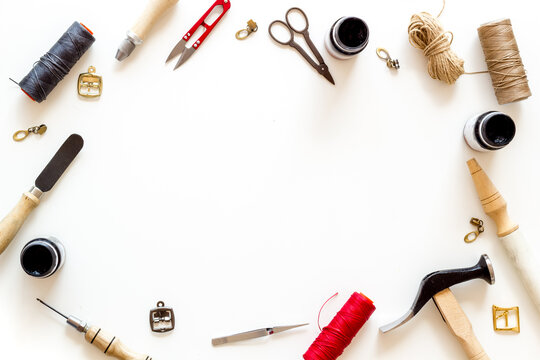 Leather crafting tools in tailor or shoemaker shop, top view