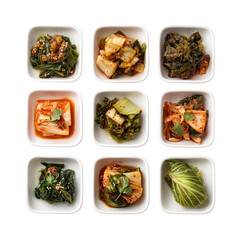 Assortment of vibrant korean banchan side dishes in white square bowls, top view