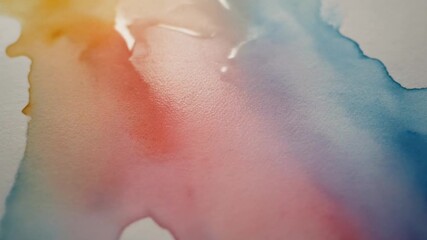 Soft pastel watercolor pigments bleeding into each other on wet paper