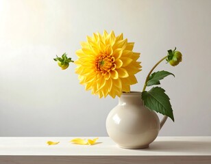 Still life of a vibrant yellow dahlia flower arrangement in a white vase
