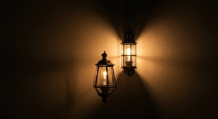 Two wall-mounted lamps, glowing warmly against a dark background