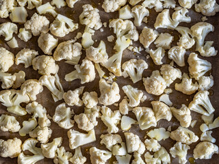 Pieces of raw cauliflower in baking tray. Top view