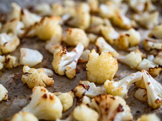 Pieces of baked cauliflower in baking tray