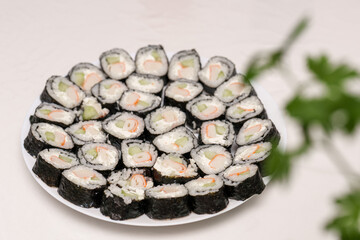 Round plate filled with delicious looking Maki Sushi rolls for lunch or dinner © andov