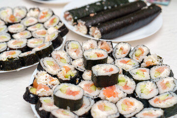 Salmon and cucumber Sushi rolls beautifully arranged on plates, a delightful Japanese culinary art for lunch or dinner